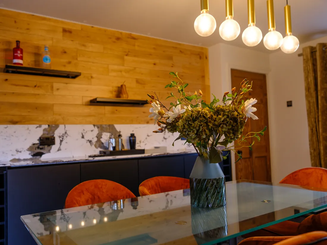 Timber-clad feature wall with floating shelves fitted by Abbey Group