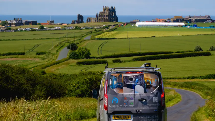 An Abbey Group branded van near Whitby Abbey