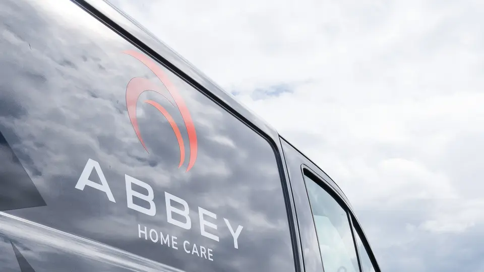 An Abbey Group van listing plumbing, heating and building services