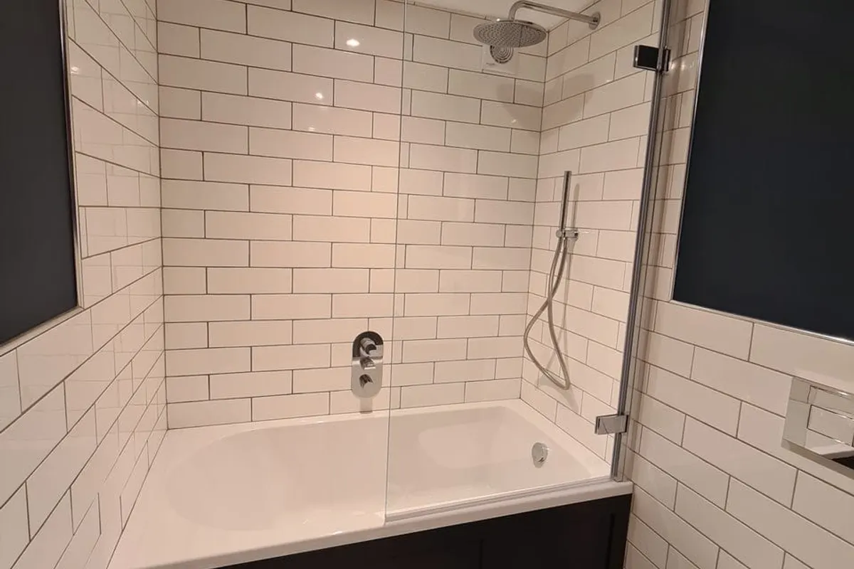 Fully tiled bathroom with a glass shower screen, renovated by Abbey Group