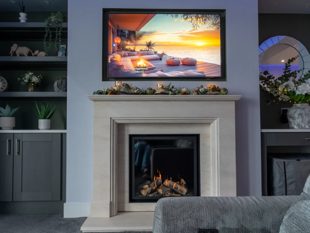 Living room with stone fireplace and bespoke alcove shelving in the Riviera renovation in Whitby by Abbey Group